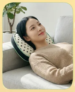 Asian woman using a polka dot cat memory foam pillow for a comfortable nap on a sofa.