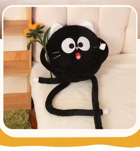 Close-up of a quirky black cat plush pillow holding a sunflower on a sofa