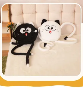 Detailed view of two funny black and white plush cat pillows with long flexible limbs