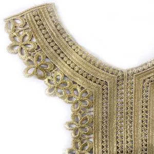 Macro view of the intricate golden hollow-out floral embroidered lace collar applique
