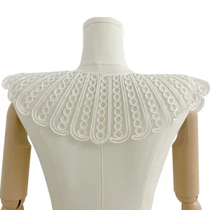 Macro view of intricate white rope embroidery on lace mesh Peter Pan collar detail