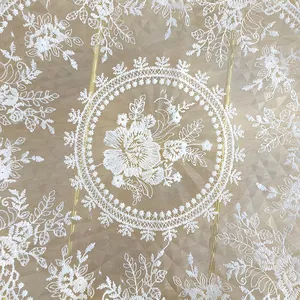 Close-up view of vintage white lace placemat with elegant floral embroidery patterns