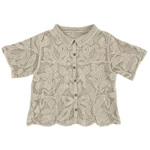 Close-up detail of cream crochet lace button-down shirt with floral embroidery