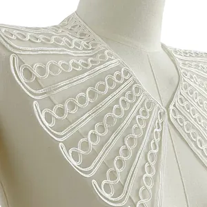 Macro view of large white rope embroidered lace fake collar showing mesh details.