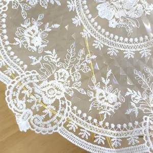 Macro view of white vintage floral embroidered lace mesh placemat for table decoration
