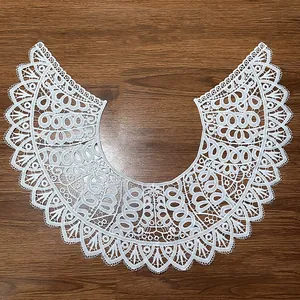 Detailed close-up of white hollow embroidered milk silk lace doll collar decoration