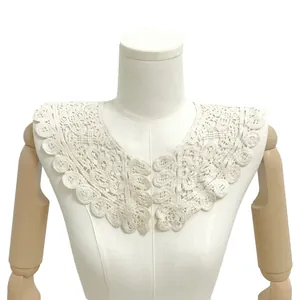 Close-up of elegant white cotton lace doll collar with hollow embroidery on mannequin