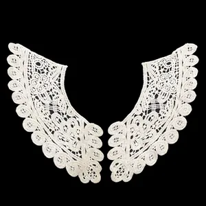 Detailed view of white cotton lace collar with intricate floral embroidery
