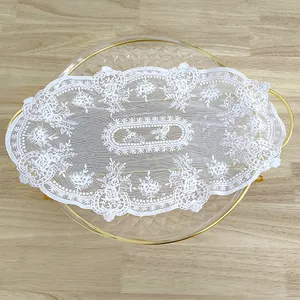 Close-up of elegant white vintage embroidered lace placemat with floral details