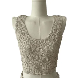 Close-up of beige crochet knit tank top with intricate floral lace pattern.
