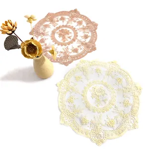 Macro view of vintage round lace placemats featuring delicate floral embroidery motifs