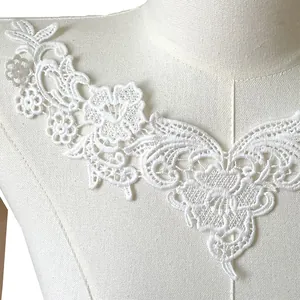 Detail of milk silk embroidered white lace collar applique with intricate floral patterns