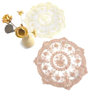 Detailed macro view of vintage floral lace doilies in cream and dusty rose colors.