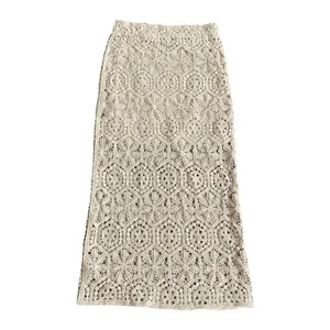 Detailed view of cream-colored crochet maxi skirt featuring hollow-out lace patterns