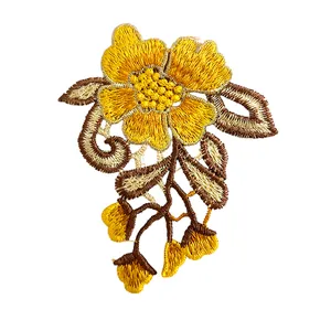 Close-up detail of yellow and brown embroidered floral lace patch for garment decoration