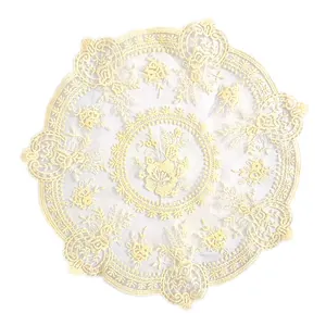 Close-up of vintage lace placemat with intricate floral embroidery and scalloped edges