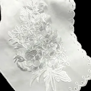 Close-up of white floral embroidered lace collar with hollowed-out details