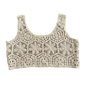 Detail of cream crochet knit vest featuring intricate floral lace and hollow-out pattern