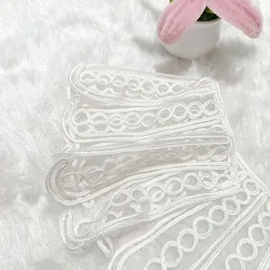 Detailed close-up of white rope embroidery lace collar with elegant floral pattern texture