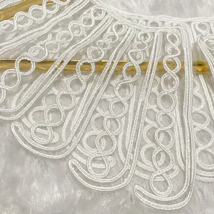 Detailed view of elegant white rope embroidery doll collar lace trim on plush background