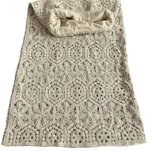 Detailed view of the beige cotton crochet lace fabric with hollow out embroidery