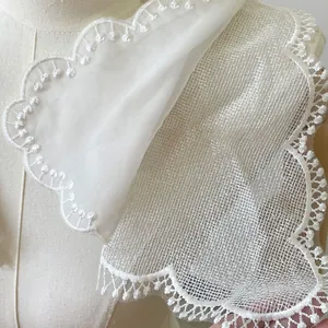 Close-up of double-layer white lace fake collar with intricate scalloped embroidery