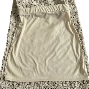 Detailed macro view of beige crochet lace dress with matching inner lining set