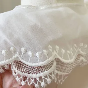 Close-up detail of white embroidered double-layered lace detachable collar with scallop edge
