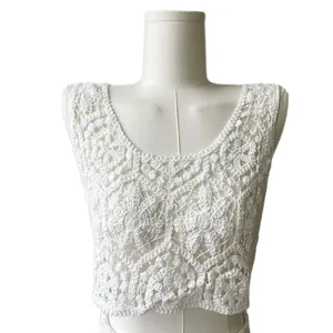 Detailed view of white cotton crochet lace vest with hollow-out floral patterns