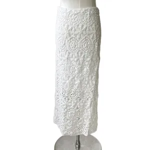 Elegant white crochet lace maxi skirt featuring an intricate hollow-out floral pattern design