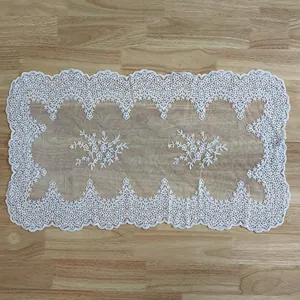Detailed view of white rectangular cotton lace tablecloth with floral embroidery
