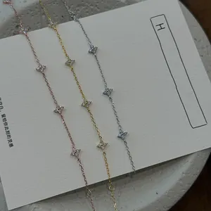 Detailed view of three s925 silver bracelets with diamond four-leaf clovers in gold and silver.
