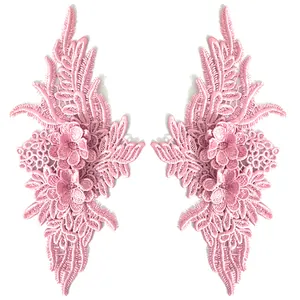 Close-up detail of symmetric pink 3D floral lace embroidery patches for DIY craft