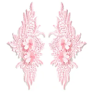 Detailed view of symmetrical pink floral lace embroidery patches for DIY sewing craft and appliques