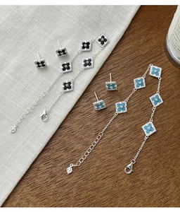 S925 silver jewelry set featuring clover stud earrings and matching bracelets with stones.