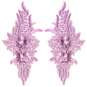 Close-up detail of two symmetrical lavender embroidered lace flower patches for DIY clothing