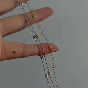 Dettaglio in primo piano di delicati bracciali in argento s925 oro, argento e rosa