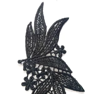 Detailed view of intricate black polyester lace floral embroidery patch for DIY clothing