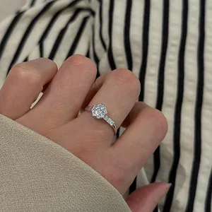 Close-up of S925 sterling silver ring with a sparkling central stone worn on a finger