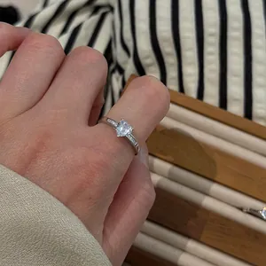 Macro detail of a sterling silver ring featuring a sparkling heart-shaped central stone