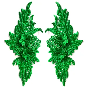 Detail view showing the fine 3D texture of green symmetrical floral embroidery patches.