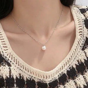 Close-up of a minimalist 925 sterling silver necklace with a single round pearl