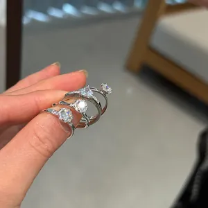 Close-up of four S925 silver rings featuring sparkling round brilliant-cut stones