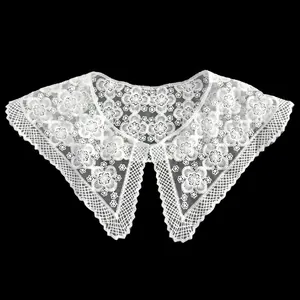 Macro detail of white milk silk embroidered lace fake collar with floral patterns.