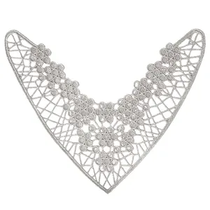 Detail view of silver metallic embroidered lace patch featuring intricate hollow flower patterns