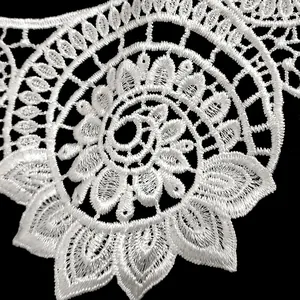 Detailed macro view of white polyester embroidered lace collar with hollowed floral patterns