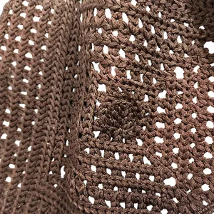 Detailed macro view of brown geometric hollow crochet lace fabric for lingerie trims