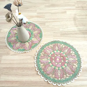 Macro view of round butterfly embroidered hollow table mat with intricate lace floral details.