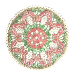 Detailed shot of circular pink butterfly embroidered lace coaster with floral motifs