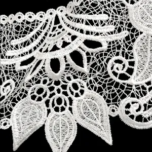Close-up detail of white polyester embroidered lace collar with hollow out floral pattern